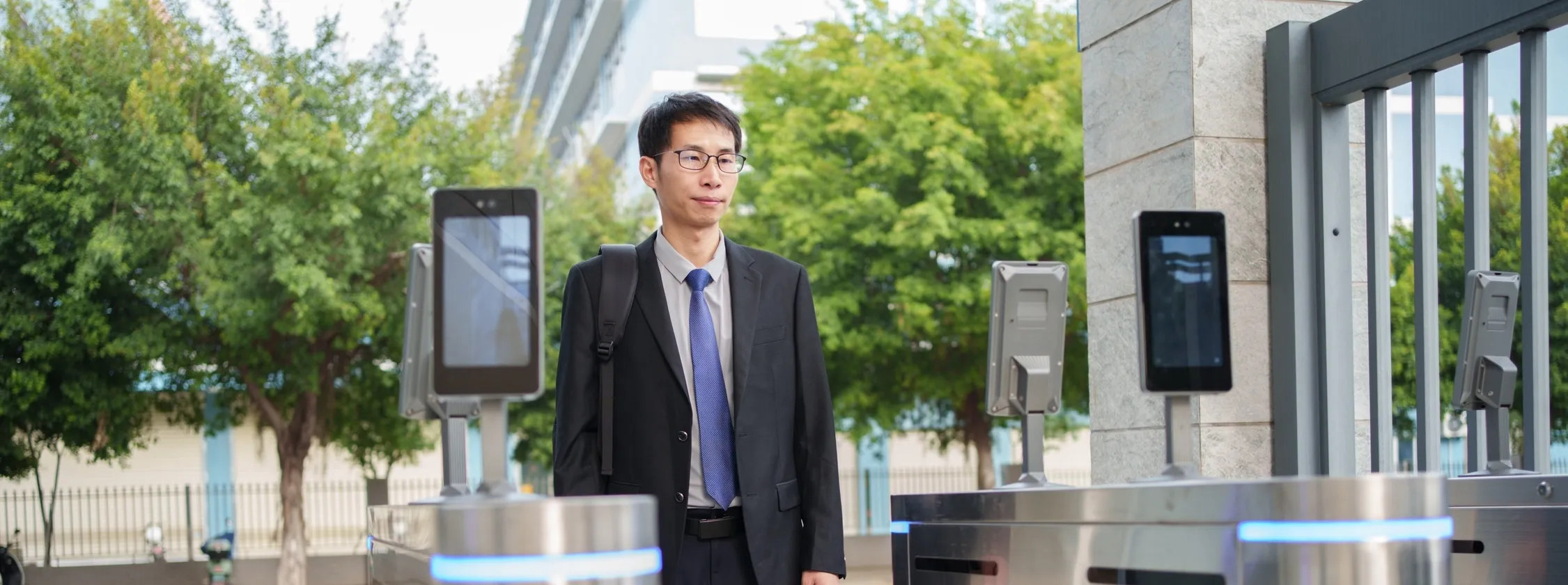 NEC biometric turnstiles with facial recognition securing building access for an office worker