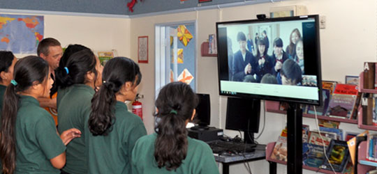 Students engaging in a video conference call with their Japanese counterparts in Minoh